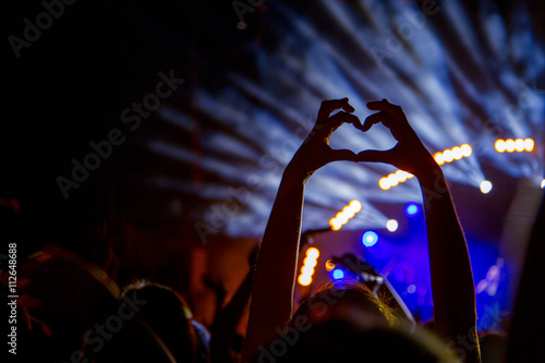 Heart shaped hands at concert, loving the artist and the festiva
