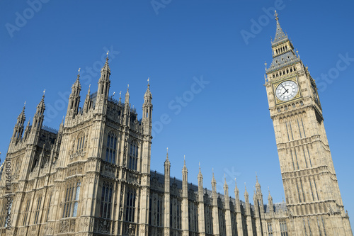 The Houses of Parliament at Westminster Palace and Big Ben shine in bright morning sun in London, UK