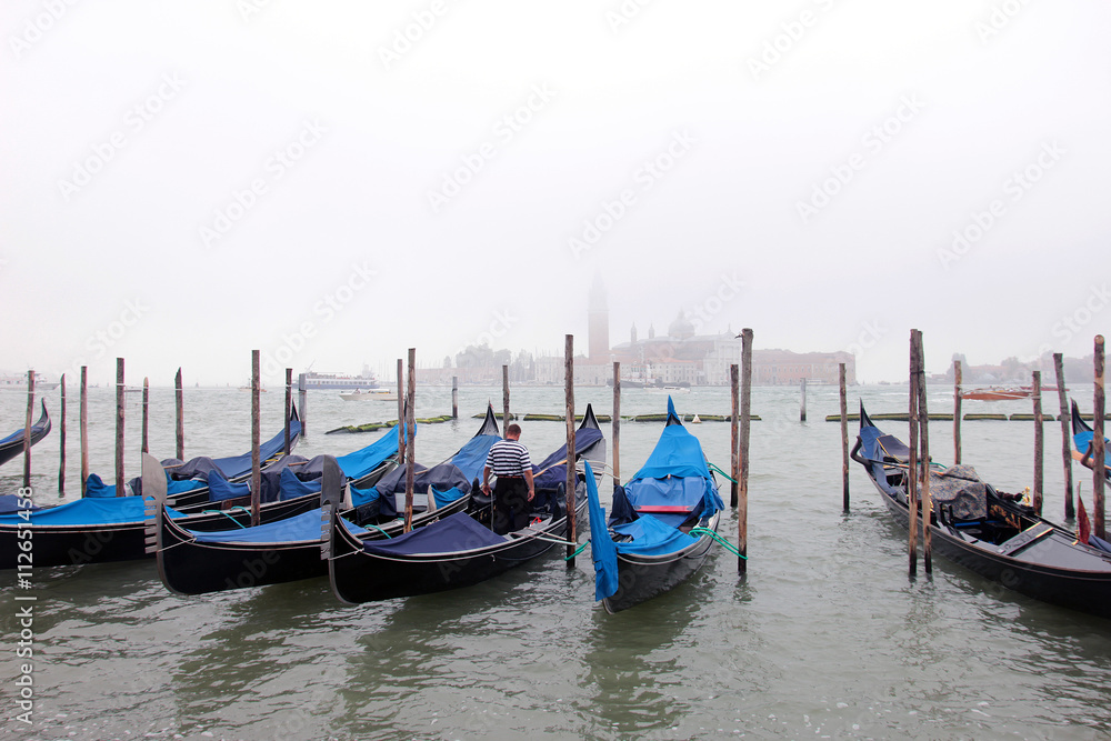 beautiful traditional venetian gondolas at the berth on the wate