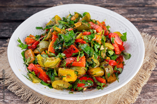 Grilled paprika salad with fresh parsley and basil
