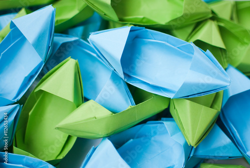 heap of blue and green paper boats  photo