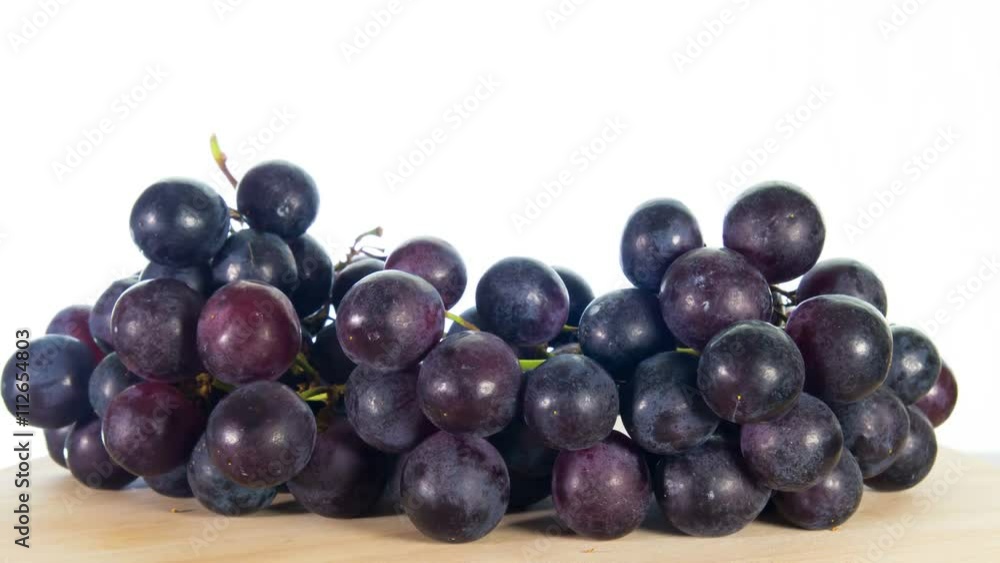 black grapes rotates, white background, 4k stop motion black grapes rotates, white background, 4k stop motion