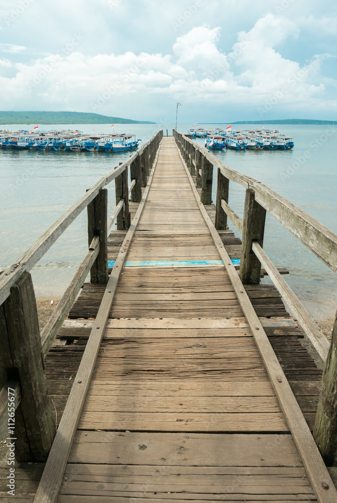 Wooden pier with Balinese boats near Taman Barrat National Park,