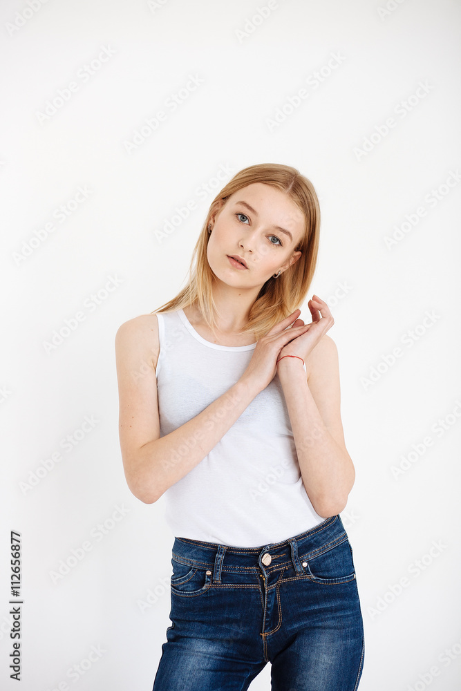Young European woman posing in studio for test photo shoot showing different poses standing Young European woman posing in studio for test photo shoot showing different poses standing
