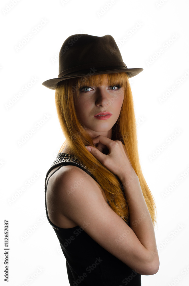 beautiful red-haired girl with a hat in the studio beautiful red-haired girl with a hat in the studio