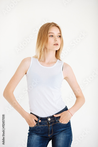 Young European woman posing in studio for test photo shoot showing different poses standing