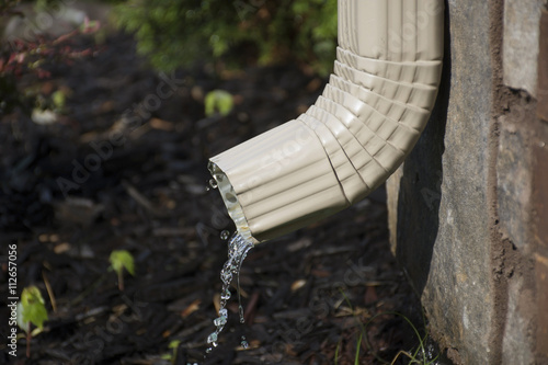 Gutter Downspout with water - side view