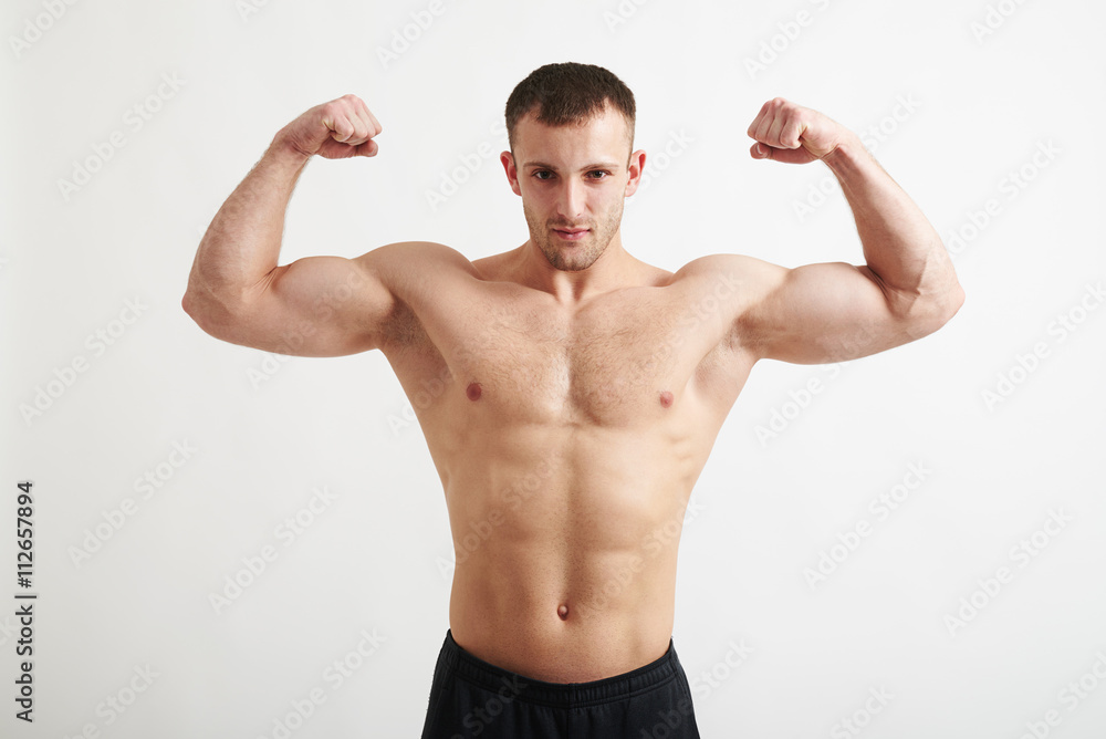 Bare-chested man showing biceps isolated on white background Bare-chested man showing biceps isolated on white background