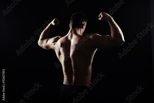 Back view of shirtless guy showing muscles