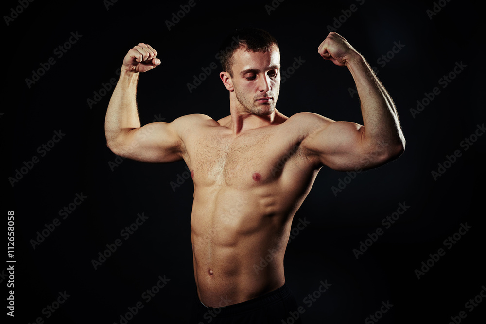 Hot guy with abs and biceps over black background Hot guy with abs and biceps over black background