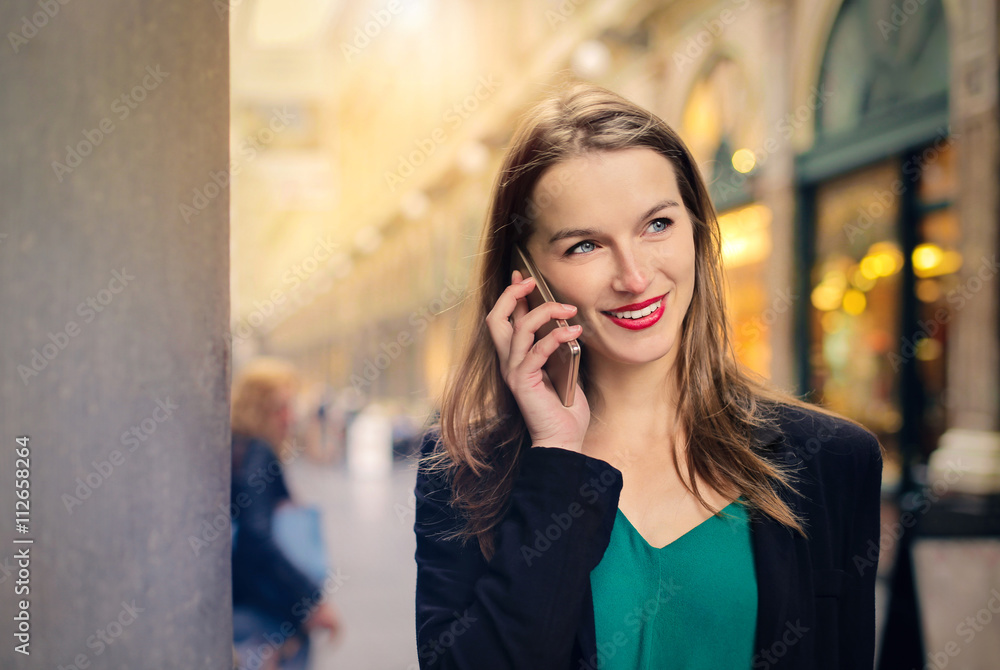 Smiling woman doing a phone call Smiling woman doing a phone call