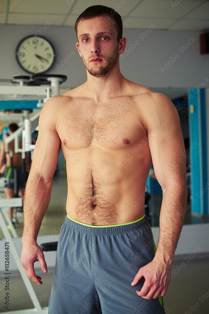 Young muscular strong man in gym Young muscular strong man in gym