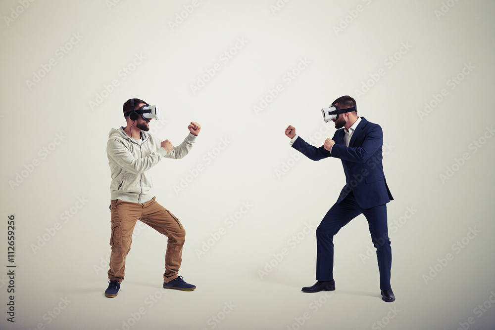 Two men in virtual reality glasses on white background Two men in virtual reality glasses on white background