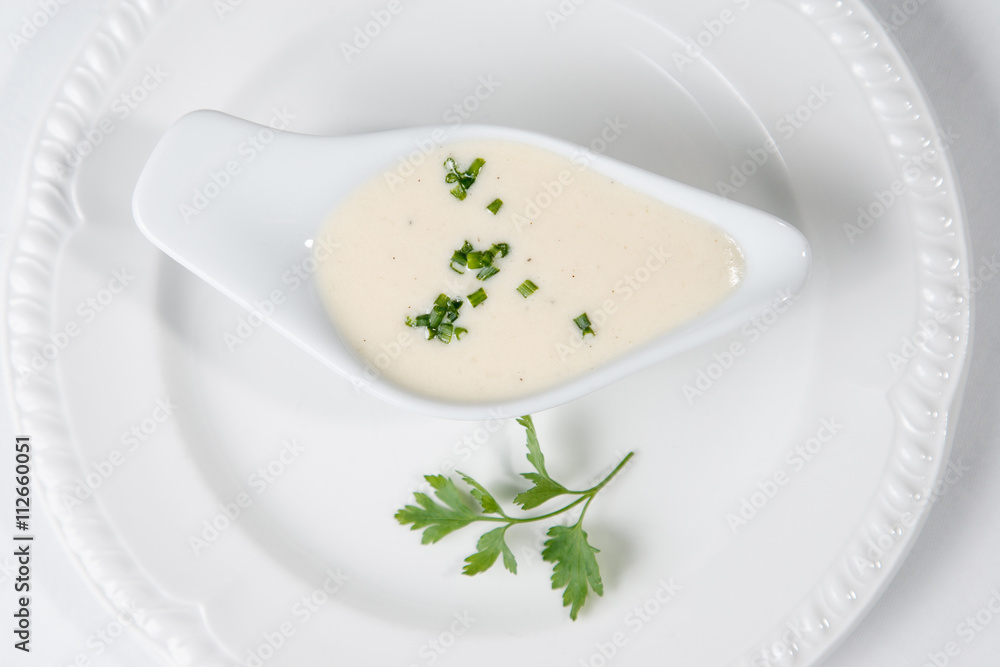 Tasty Bechamel sauce or white sauce with fresh greenery Tasty Bechamel sauce or white sauce with fresh greenery
