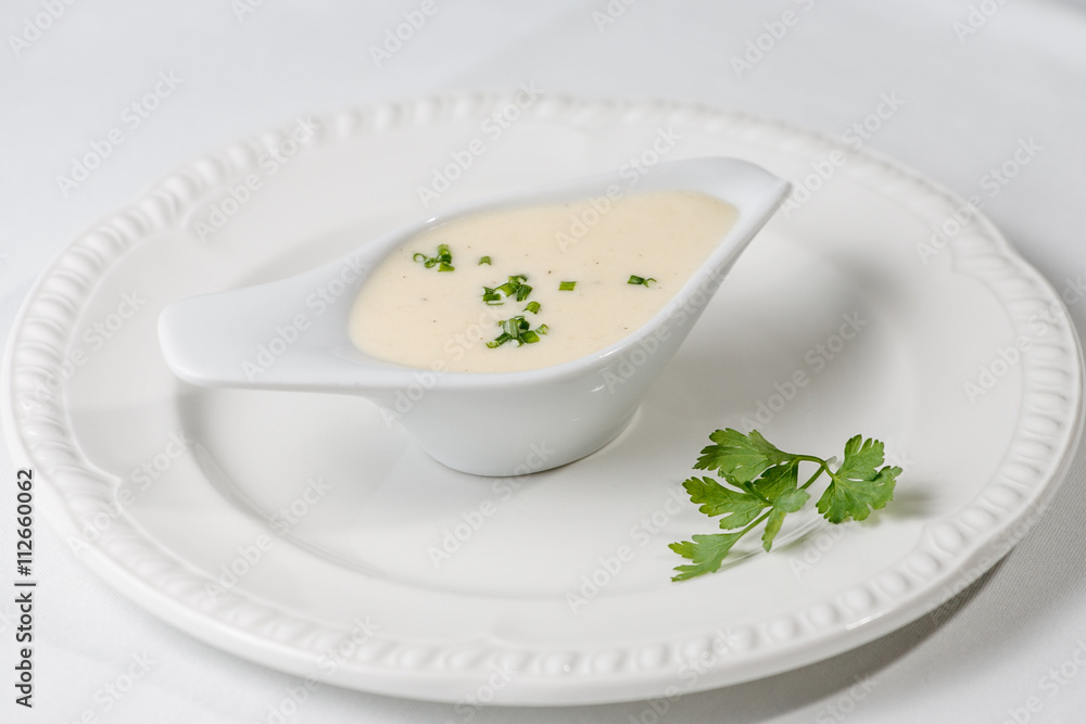 Tasty Bechamel sauce or white sauce with fresh greenery Tasty Bechamel sauce or white sauce with fresh greenery