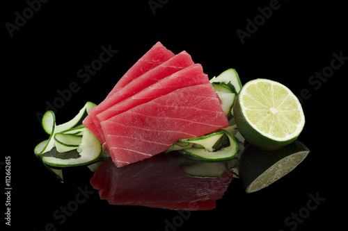 Tuna sashimi over black background