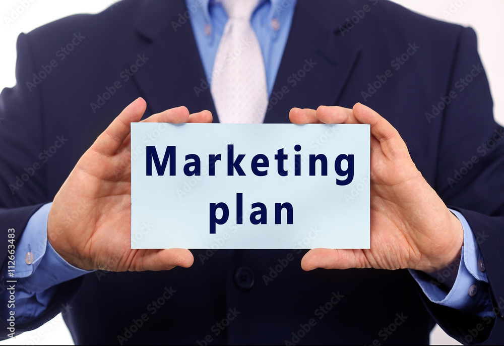 Business man hold paper marketing plan text on it Business man hold paper marketing plan text on it