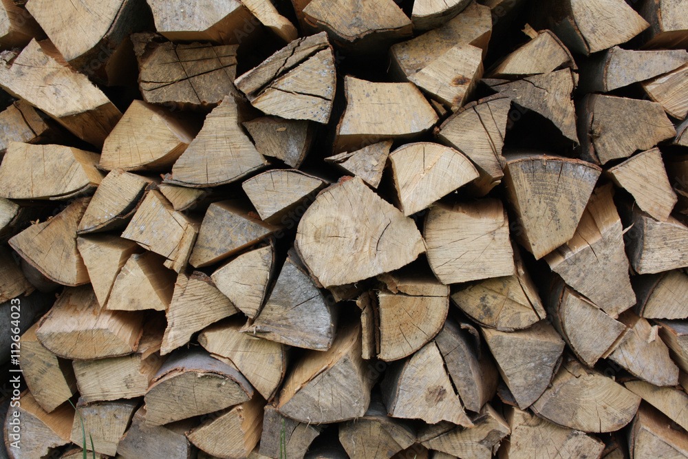 Background of dry chopped firewood logs in a pile Background of dry chopped firewood logs in a pile