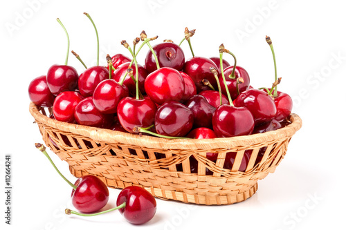 cherries in a wicker basket isolated on white background