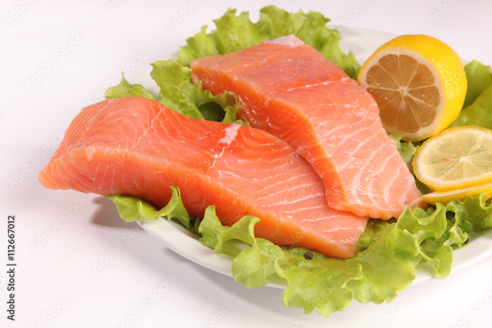 salmon on a plate with salad and lemon salmon on a plate with salad and lemon