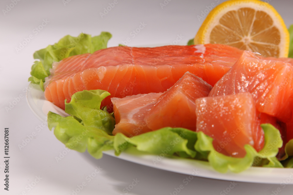 salmon on a plate with salad and lemon salmon on a plate with salad and lemon