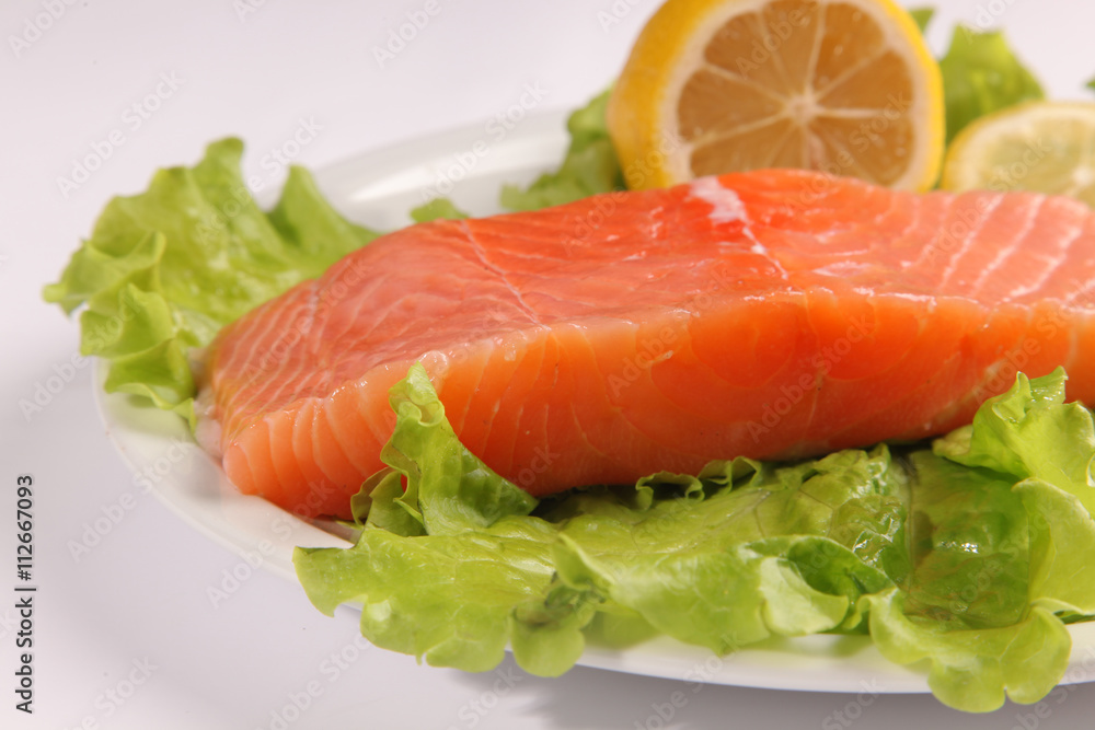 salmon on a plate with salad and lemon salmon on a plate with salad and lemon