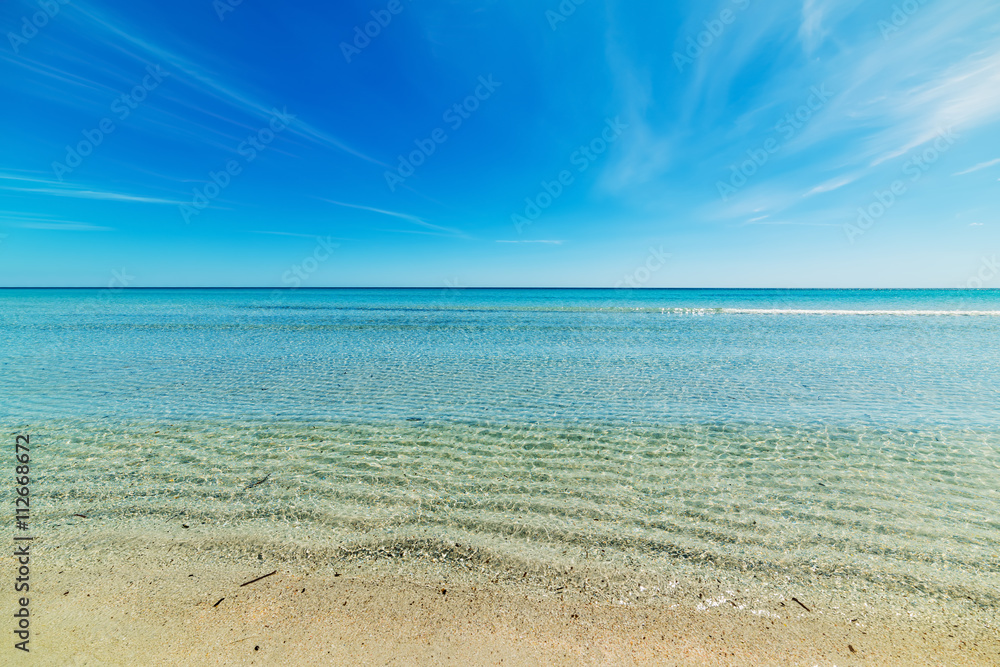 San Teodoro shoreline under a blue sky