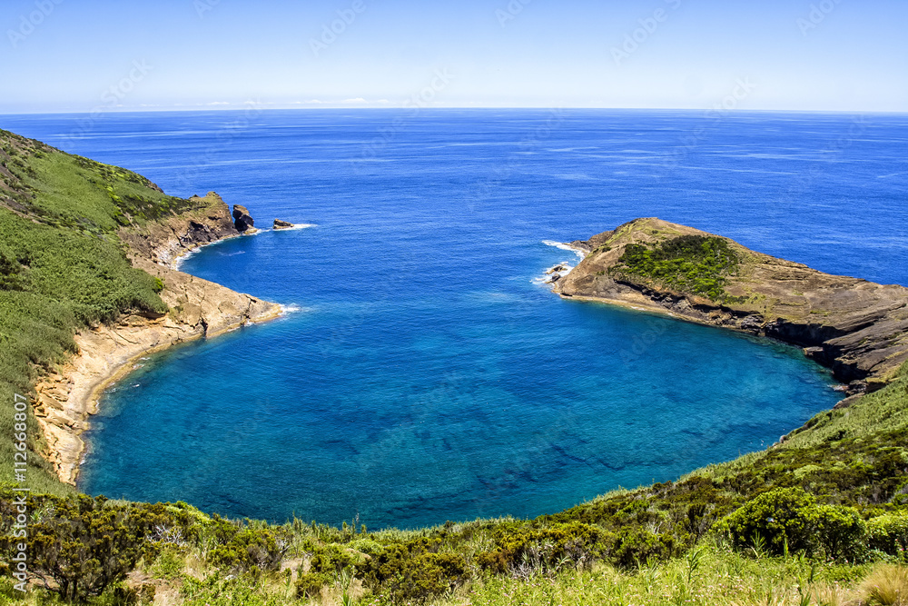 Bay in Azores in Atlantic ocean on a background of of blue sky and juicy greenery