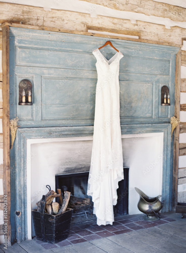 Wedding dress hanging up on fireplace Wedding dress hanging up on fireplace