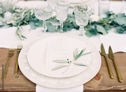 Place setting on wooden table photo