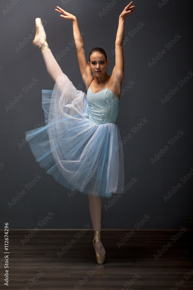 Naklejka premium young ballerina in ballet pose classical dance
