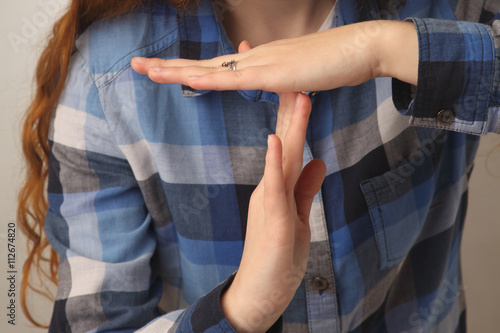 Girl showing stop hand sign gesture (Body language, gestures, ps