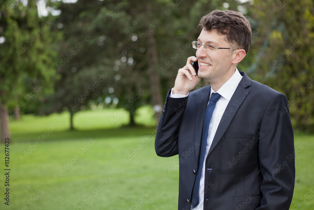 businessman talking to his mobile phone. businessman talking to his mobile phone.
