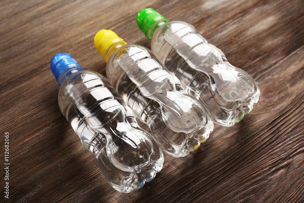 Bottled water on the wooden table, close up Bottled water on the wooden table, close up