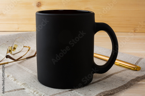 Obraz na plátně Black coffee mug mockup with glasses and pen