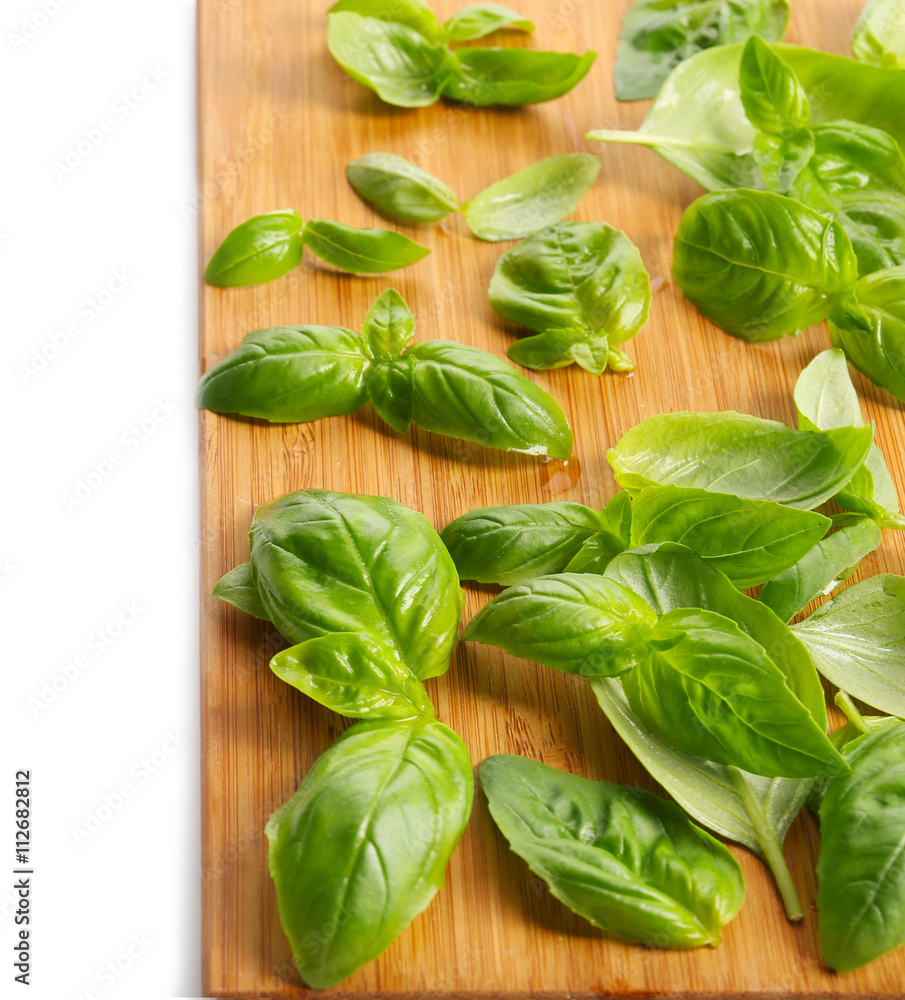 Fresh basil leaves on wooden board Fresh basil leaves on wooden board
