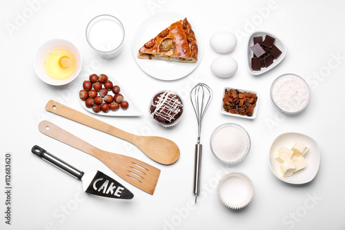 Cake ingredients on white table. Flat lay © Africa Studio