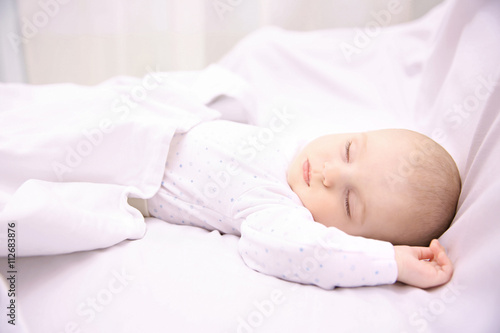 Beautiful sleeping baby in bed