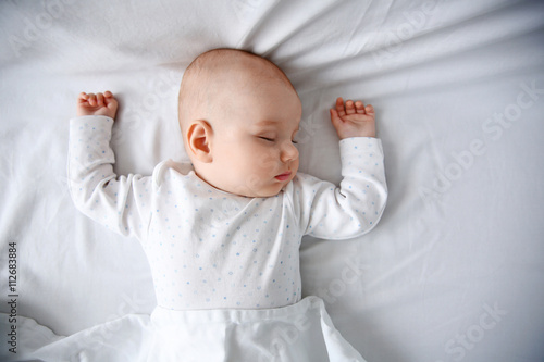 Beautiful sleeping baby in bed