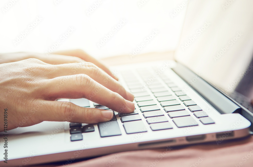 Close up woman hands typing on laptop keyboard at home and sunlight, indoor. Close up woman hands typing on laptop keyboard at home and sunlight, indoor.
