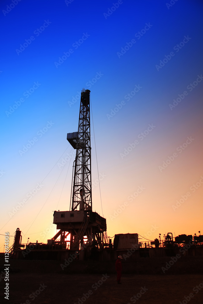 The silhouette of oilfield derrick