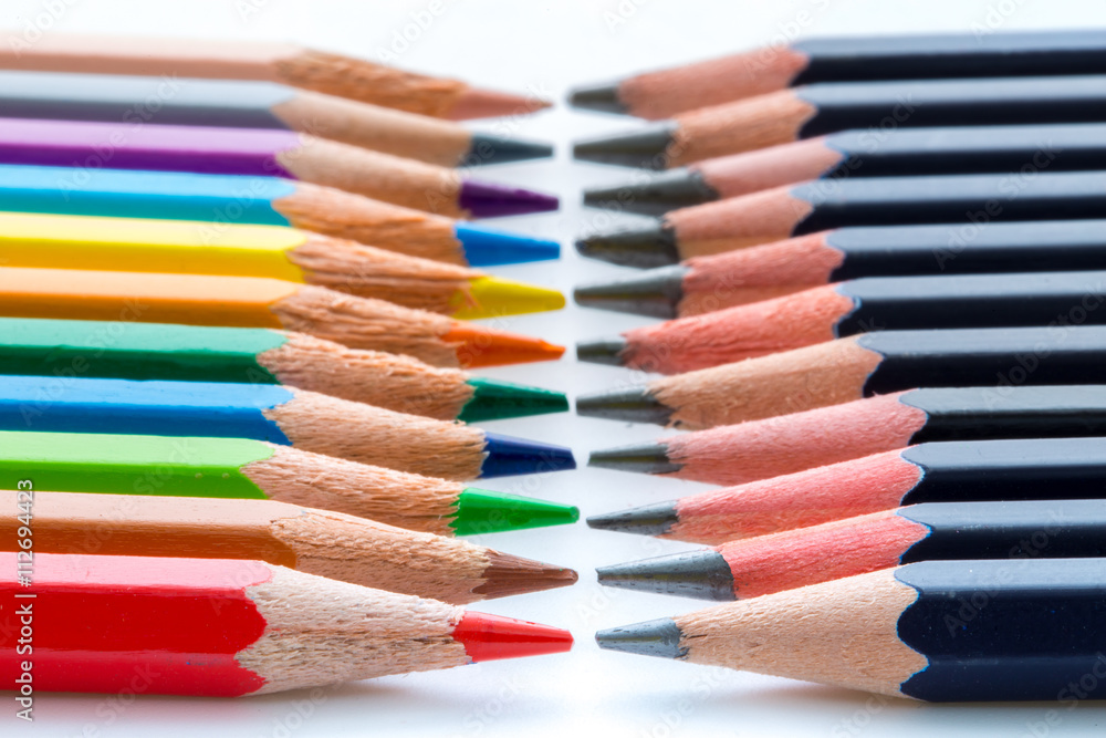 Obraz premium Several colored and black pencils in contrast