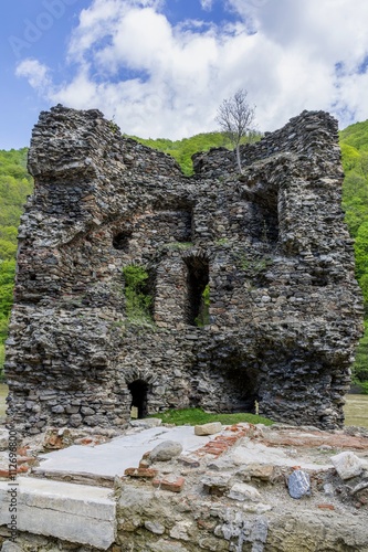  Medieval broken tower. The custom-house on Olt river in Carpathian mountains. photo