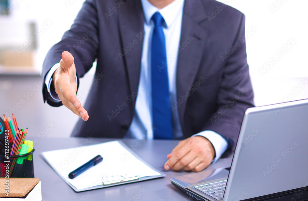 Young businessman working in office, sitting at a table Young businessman working in office, sitting at a table