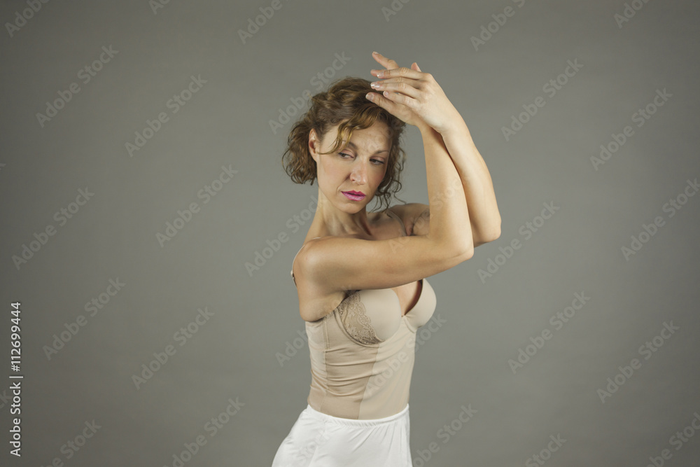 Young expressive ballerina with practicing ballet by herself