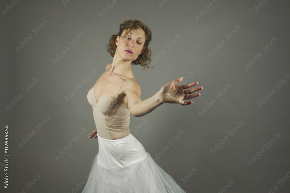 Fototapeta premium Young expressive ballerina with practicing ballet by herself