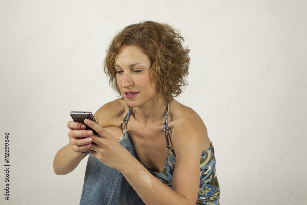 Portrait of smiley casual beautiful woman in jeans with the phon Portrait of smiley casual beautiful woman in jeans with the phon