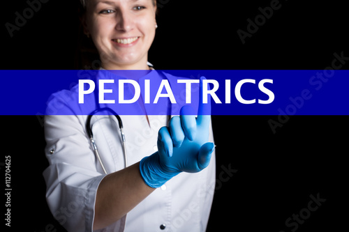 Internet and technology concept. smiling female doctor presses a finger on a virtual screen. pediatrics written on a virtual panel. Internet technologies in medicine photo