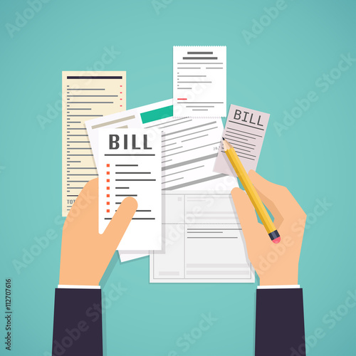 Paying bills. Hands holding bills and pencil. Payment of utility photo