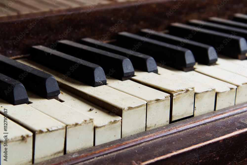 Old broken disused piano with damaged keys Old broken disused piano with damaged keys